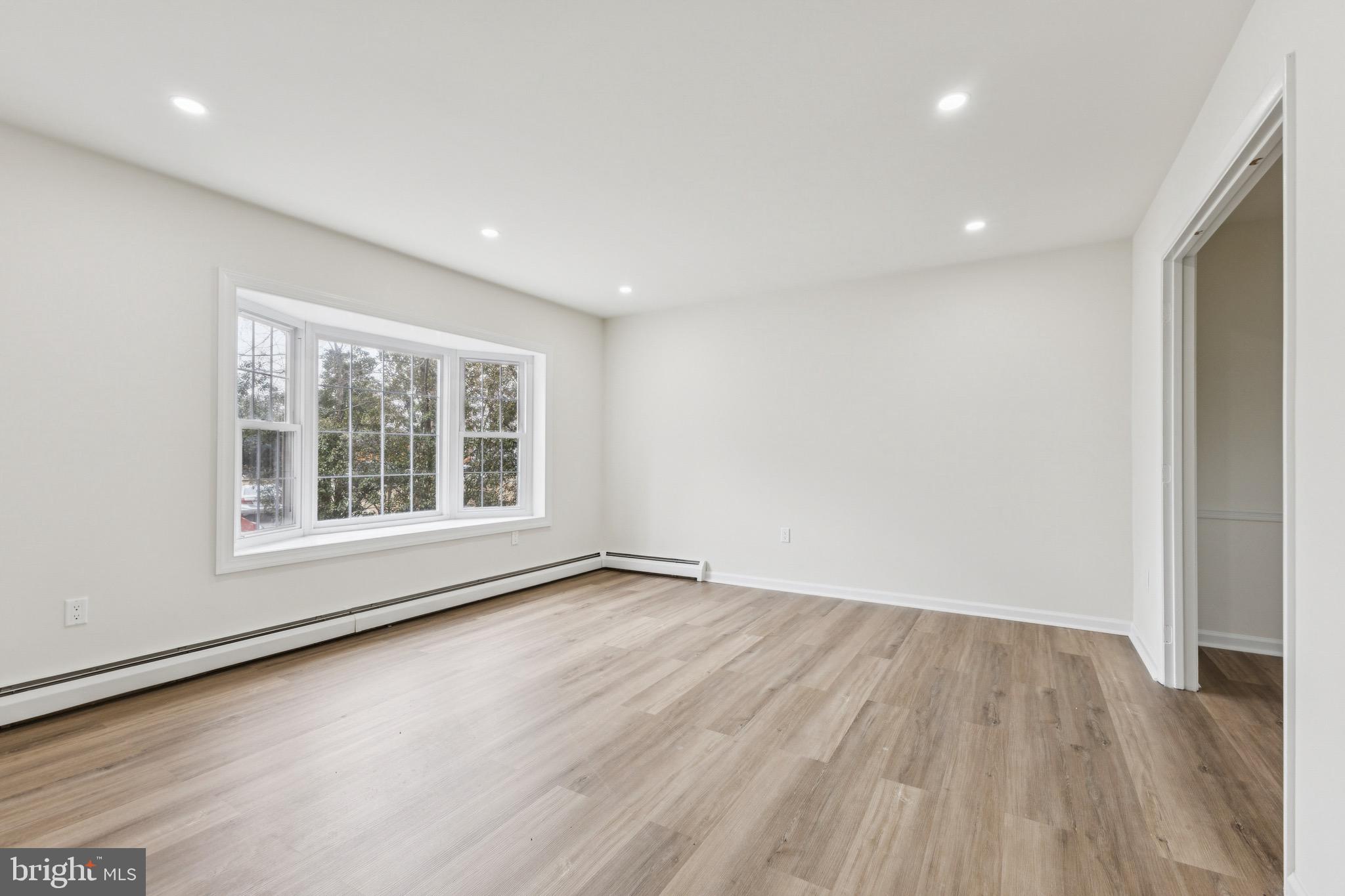 2202 Princess Anne Lane Woodbridge, VA 22191 - Photo 19 of 25 a view of an empty room with wooden floor and a window