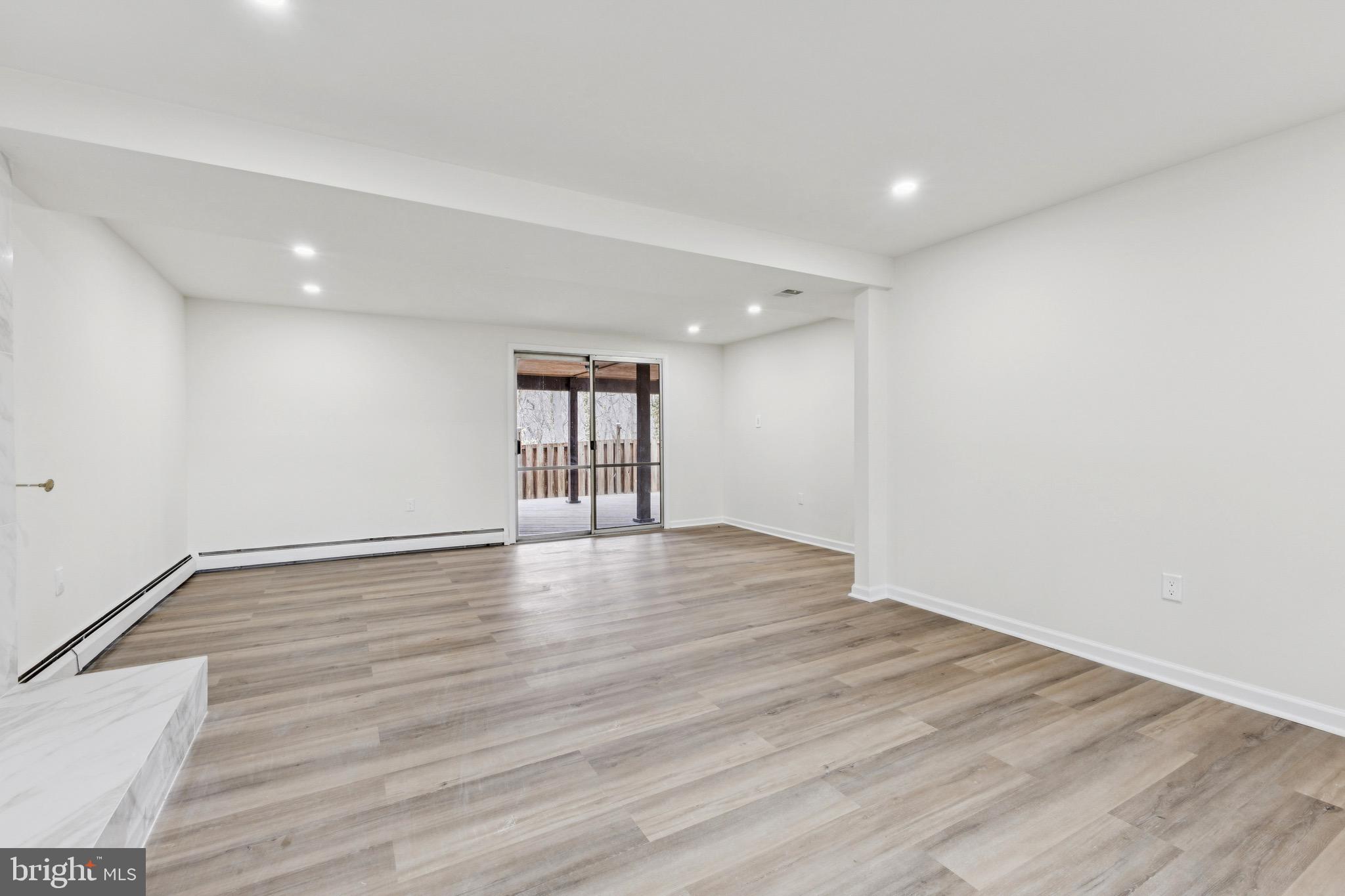 2202 Princess Anne Lane Woodbridge, VA 22191 - Photo 21 of 25 a view of empty room with wooden floor and fan