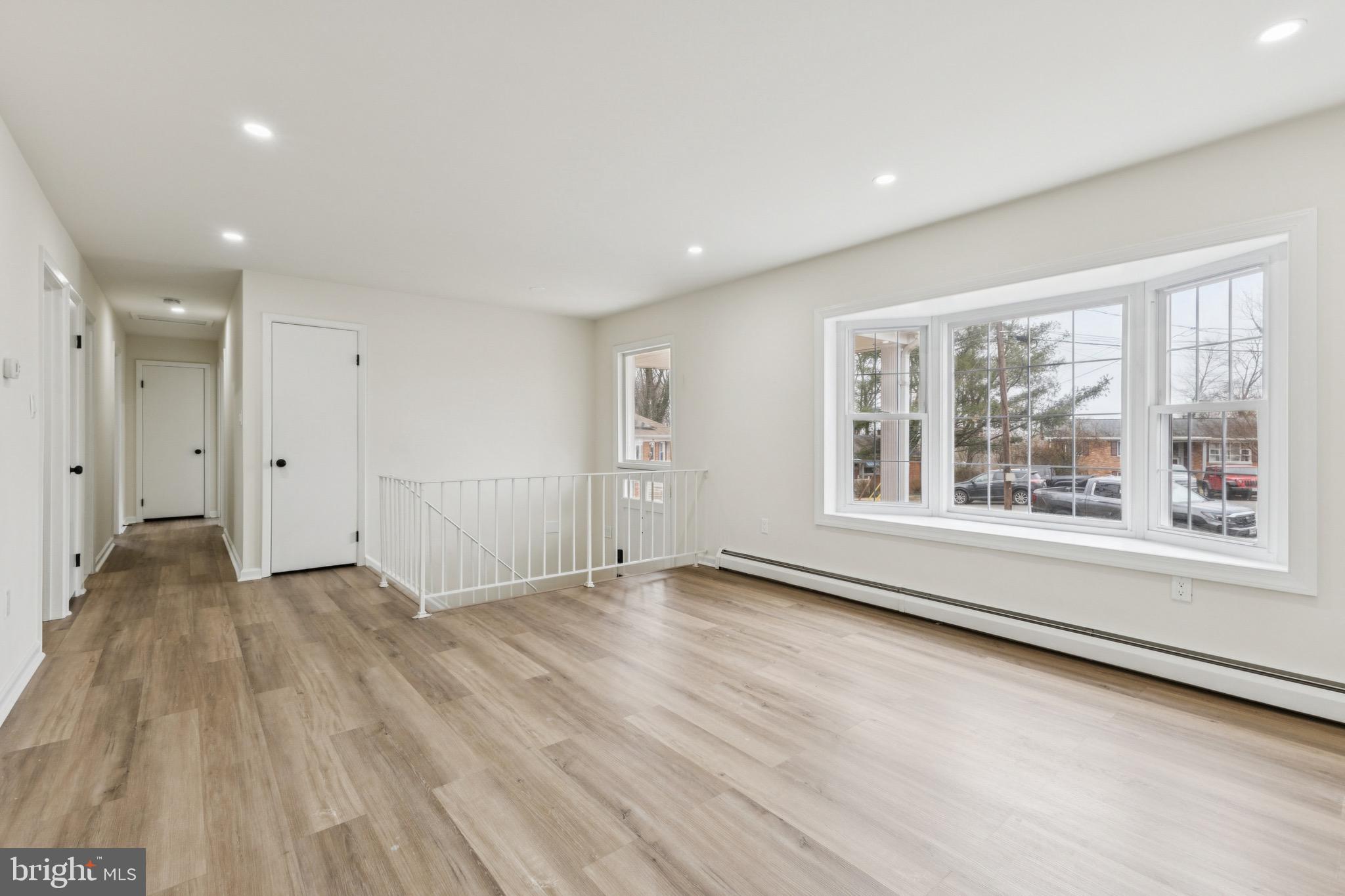 2202 Princess Anne Lane Woodbridge, VA 22191 - Photo 3 of 25 a view of an empty room with a window and wooden floor