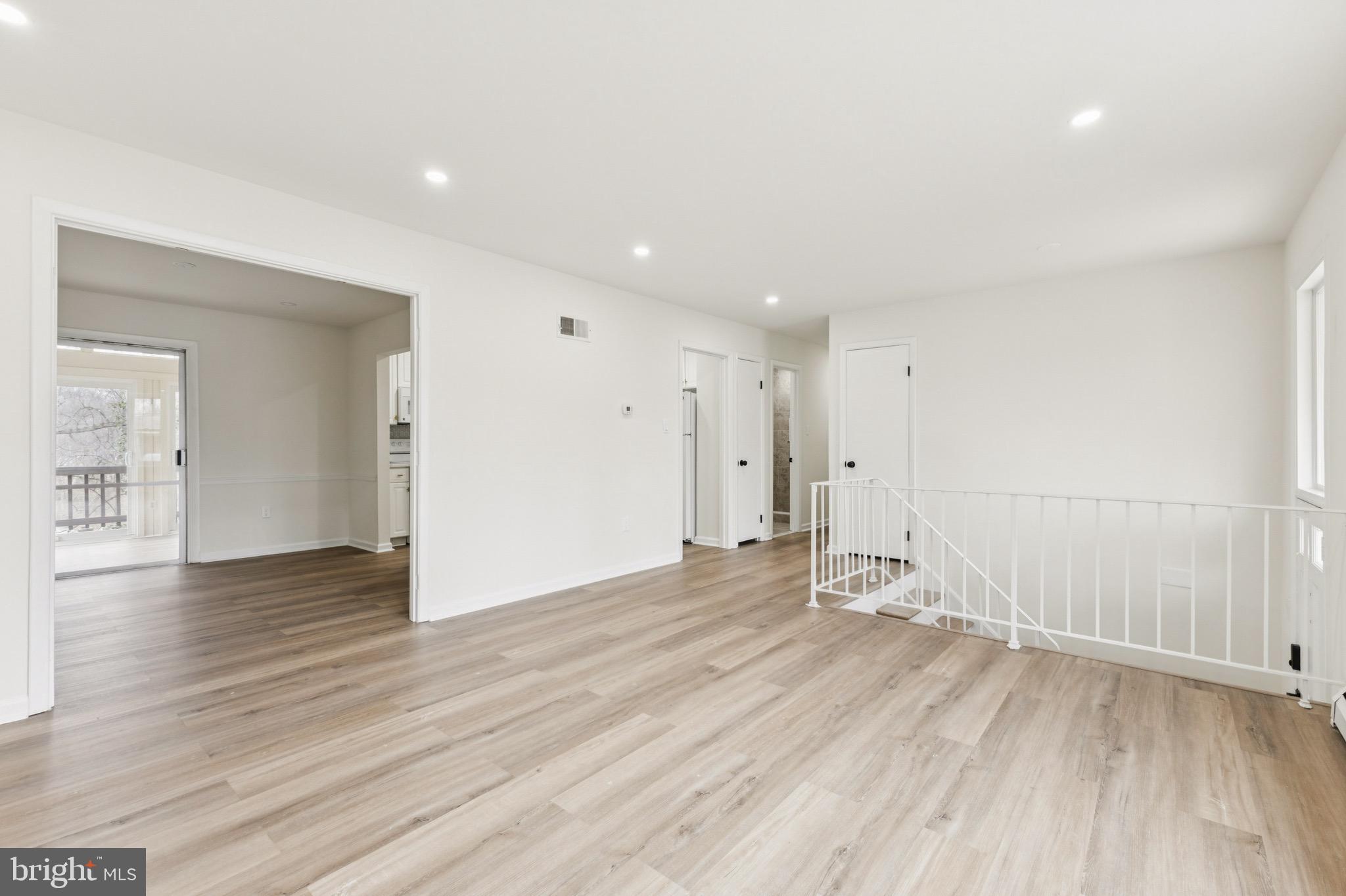 2202 Princess Anne Lane Woodbridge, VA 22191 - Photo 4 of 25 an empty room with wooden floor and windows