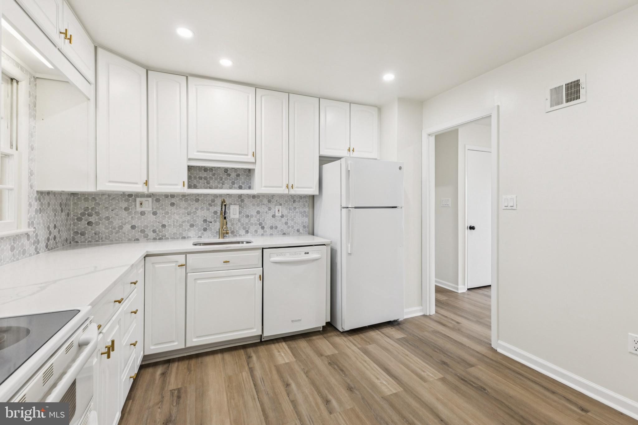 2202 Princess Anne Lane Woodbridge, VA 22191 - Photo 5 of 25 a kitchen with stainless steel appliances granite countertop a refrigerator sink and white cabinets