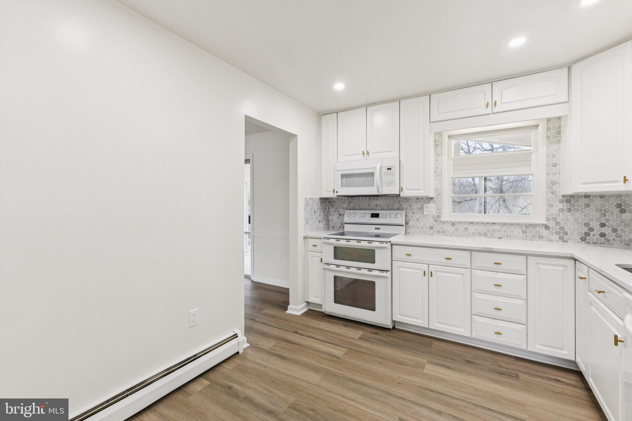 2202 Princess Anne Lane Woodbridge, VA 22191 - Photo 6 of 25 a kitchen with granite countertop white cabinets and white appliances