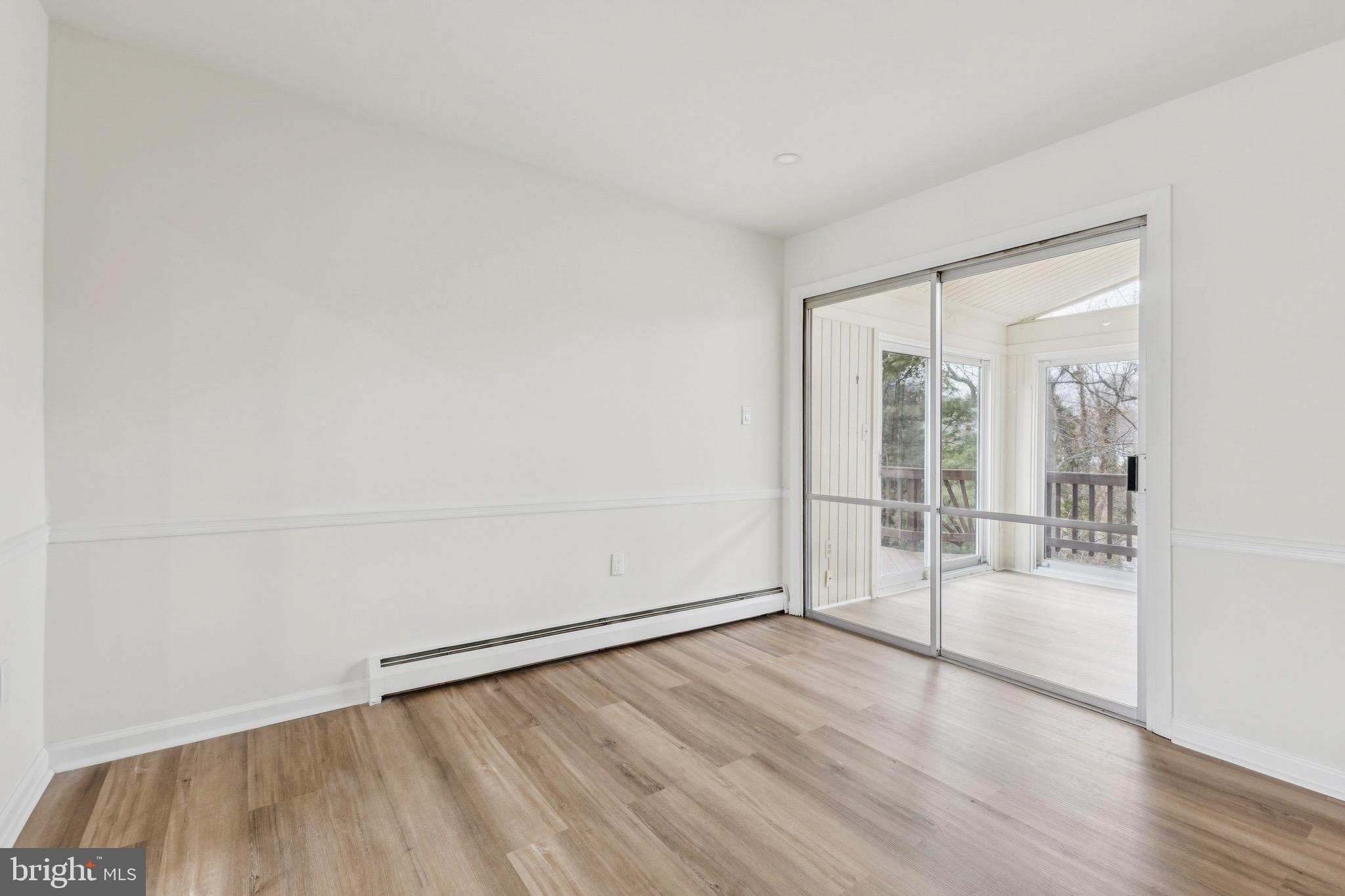 2202 Princess Anne Lane Woodbridge, VA 22191 - Photo 10 of 25 an empty room with wooden floor and windows