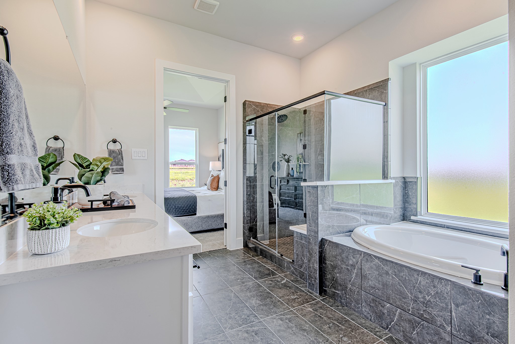141 Peninsula Point Drive Montgomery, TX 77356 - Photo 24 of 47 The elegant en-suite bath features a glass-enclosed shower, soaking tub, and direct access to the spacious primary suite—creating a seamless flow of comfort and function.