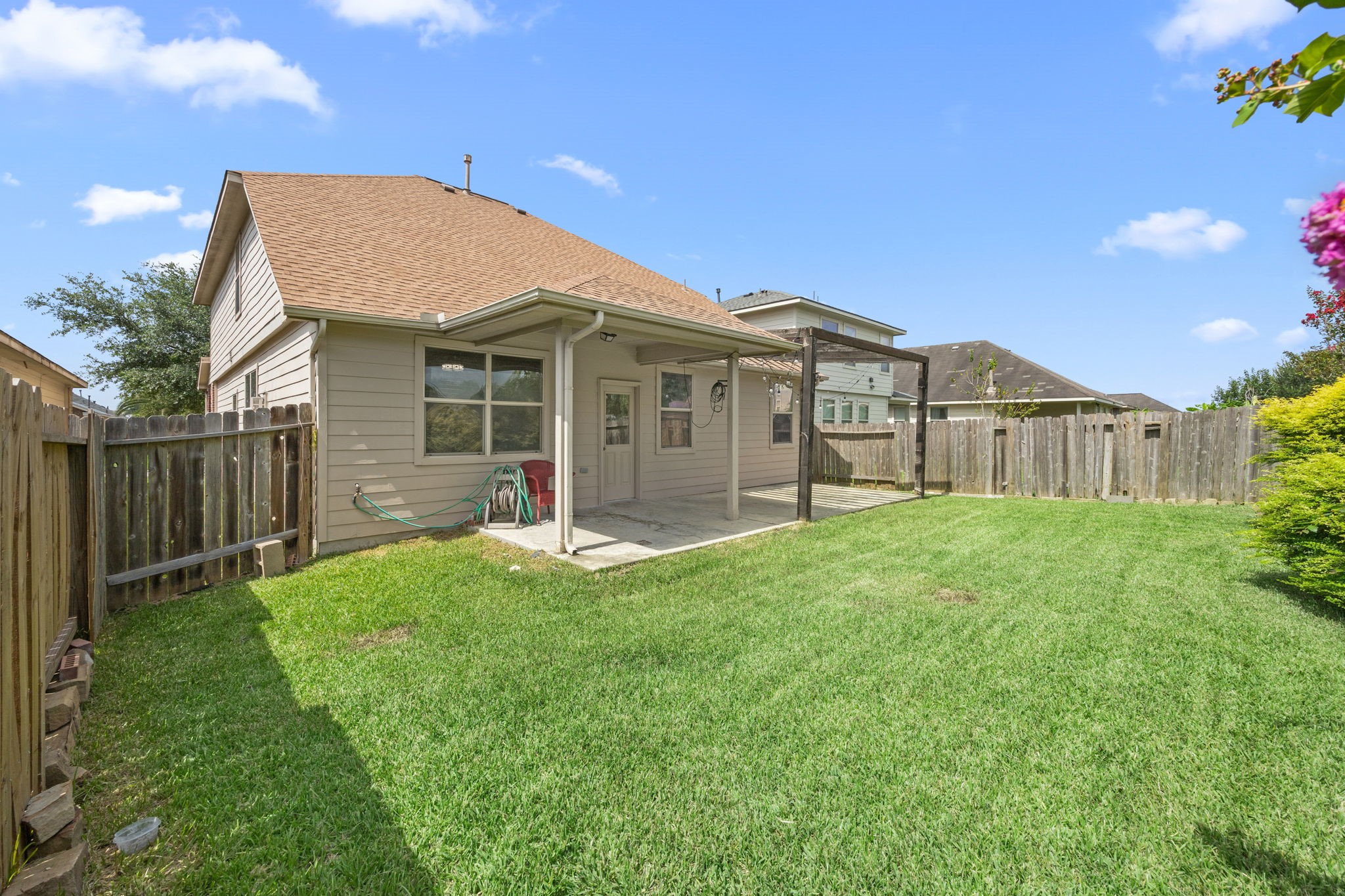 3606 Canvasback Lane Houston, TX 77047 - Photo 28 of 29 Enjoy a fully fenced backyard with plenty of green space for pets, play, or entertaining, complete with a covered patio and pergola for year-round outdoor living.