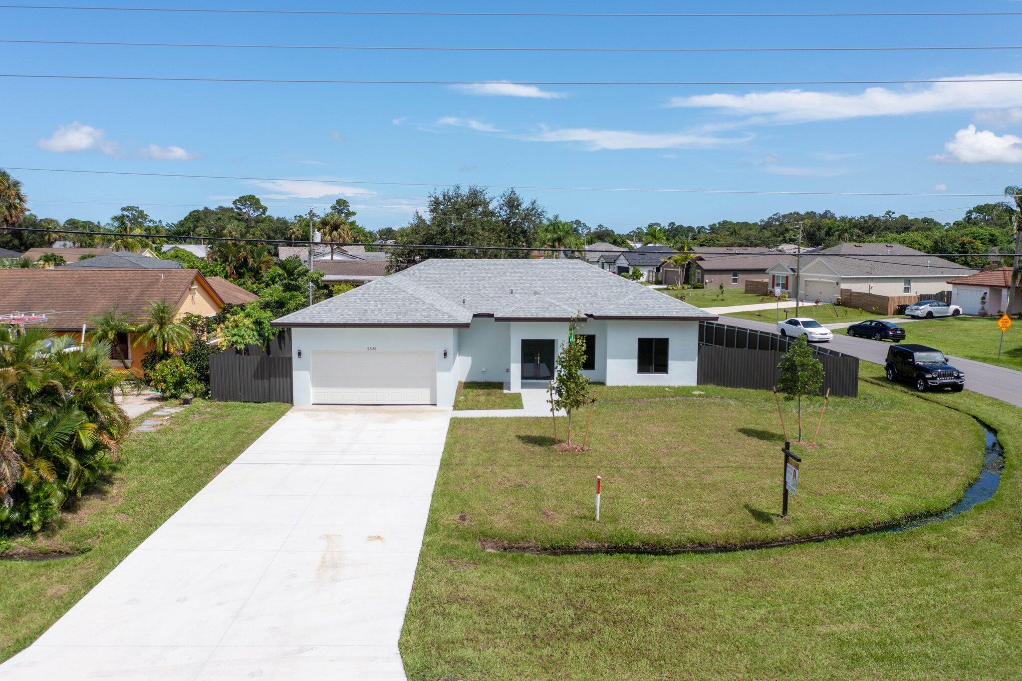 2581 Southwest Savona Boulevard Port St. Lucie, FL 34953 - Photo 1 of 24 a view of a house with a yard