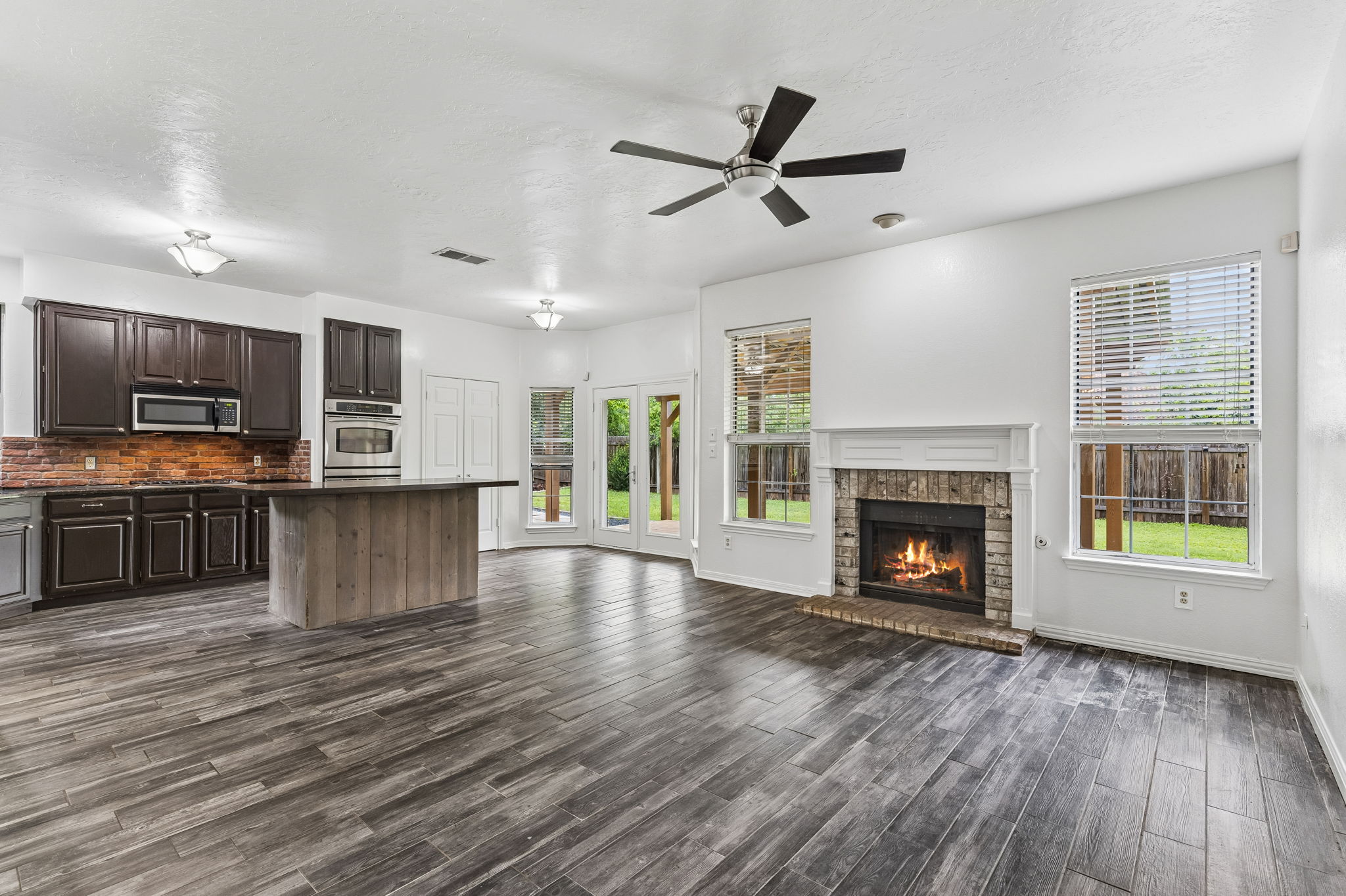 10400 O'Rourk Lane Austin, TX 78739 - Photo 19 of 33 a view of kitchen with microwave a stove and a wooden floors