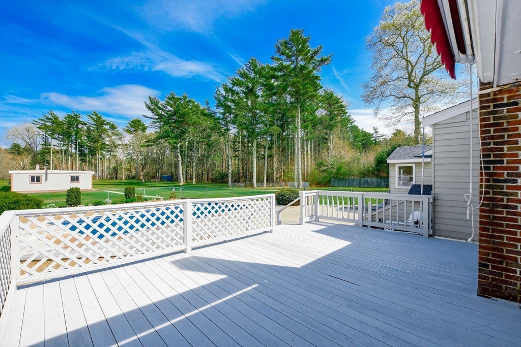 60 Mendell Road Rochester, MA 02770 - Photo 12 of 42 a view of a deck with a table and chairs with wooden floor and fence