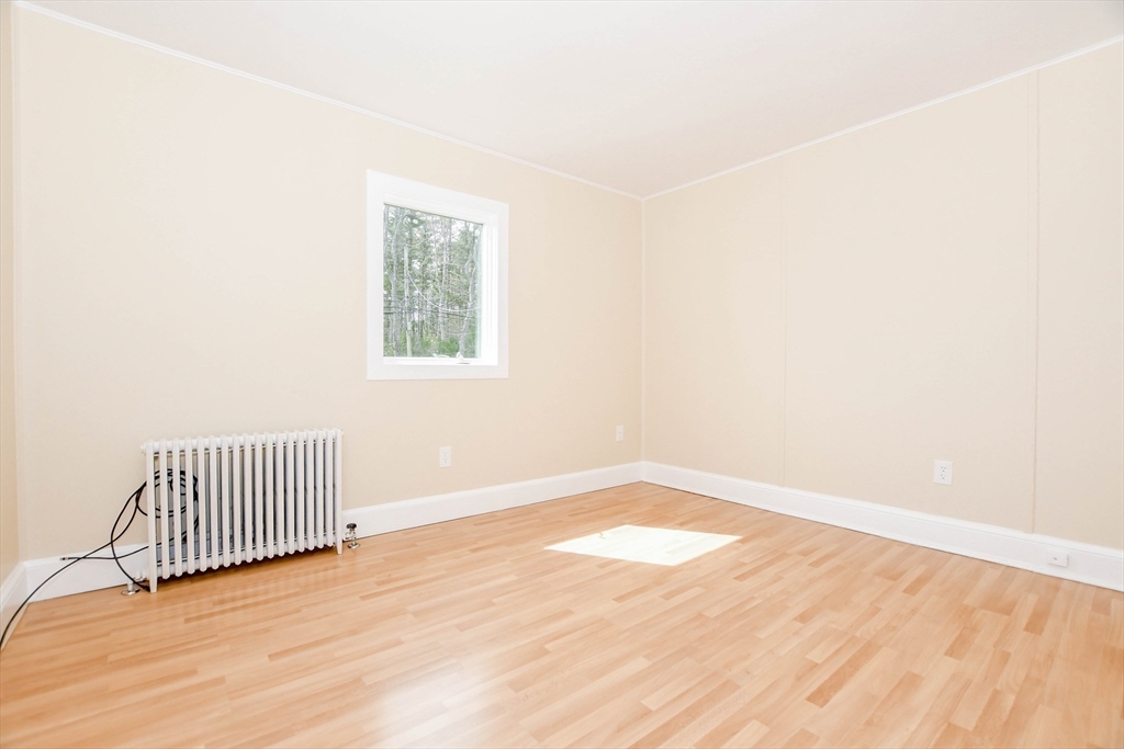 60 Mendell Road Rochester, MA 02770 - Photo 27 of 42 an empty room with wooden floor and windows