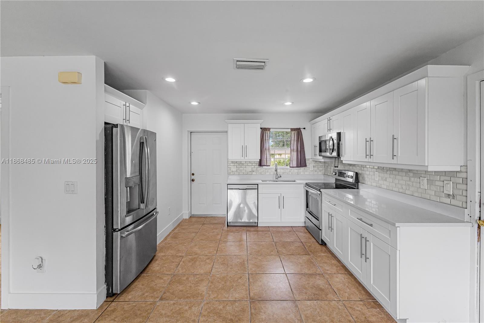 804 Monroe, Unit DR LaBelle, FL 33936 - Photo 2 of 10 a large kitchen with a large counter top stainless steel appliances and cabinets