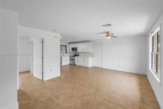 a view of a kitchen with a sink and a refrigerator