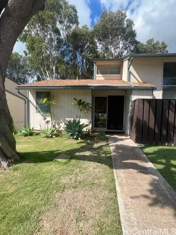 a view of a house with yard and a garden
