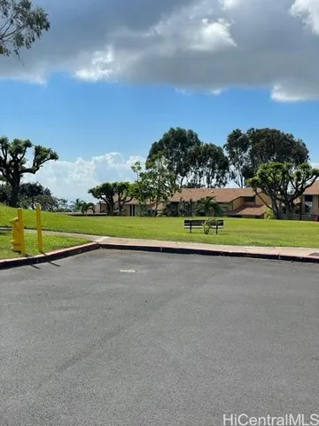 a view of a golf course with parking space