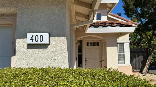 a view of a front door and potted plants