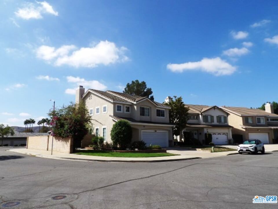 2703 Titania Place Simi Valley, CA 93063 - Photo 2 of 20 a front view of a house with a yard and parking