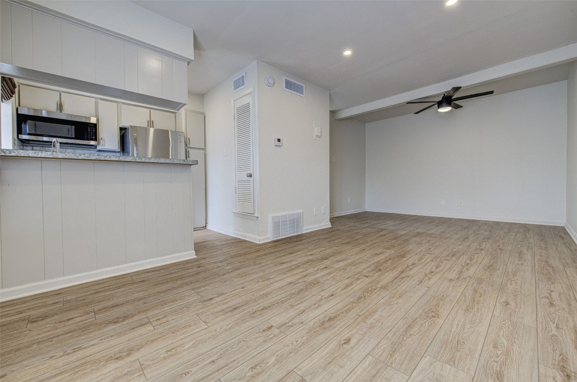 Unfurnished living room with a ceiling fan, light wood-style flooring, and recessed lighting