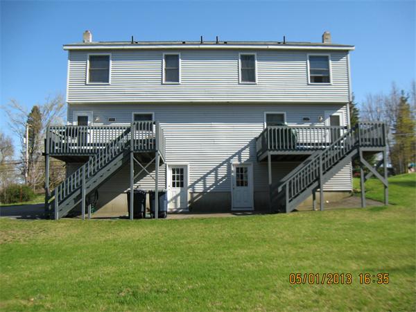 220-222 Main Street Rutland, MA 01543 - Photo 3 of 28 a view of a house with a backyard and a wooden deck