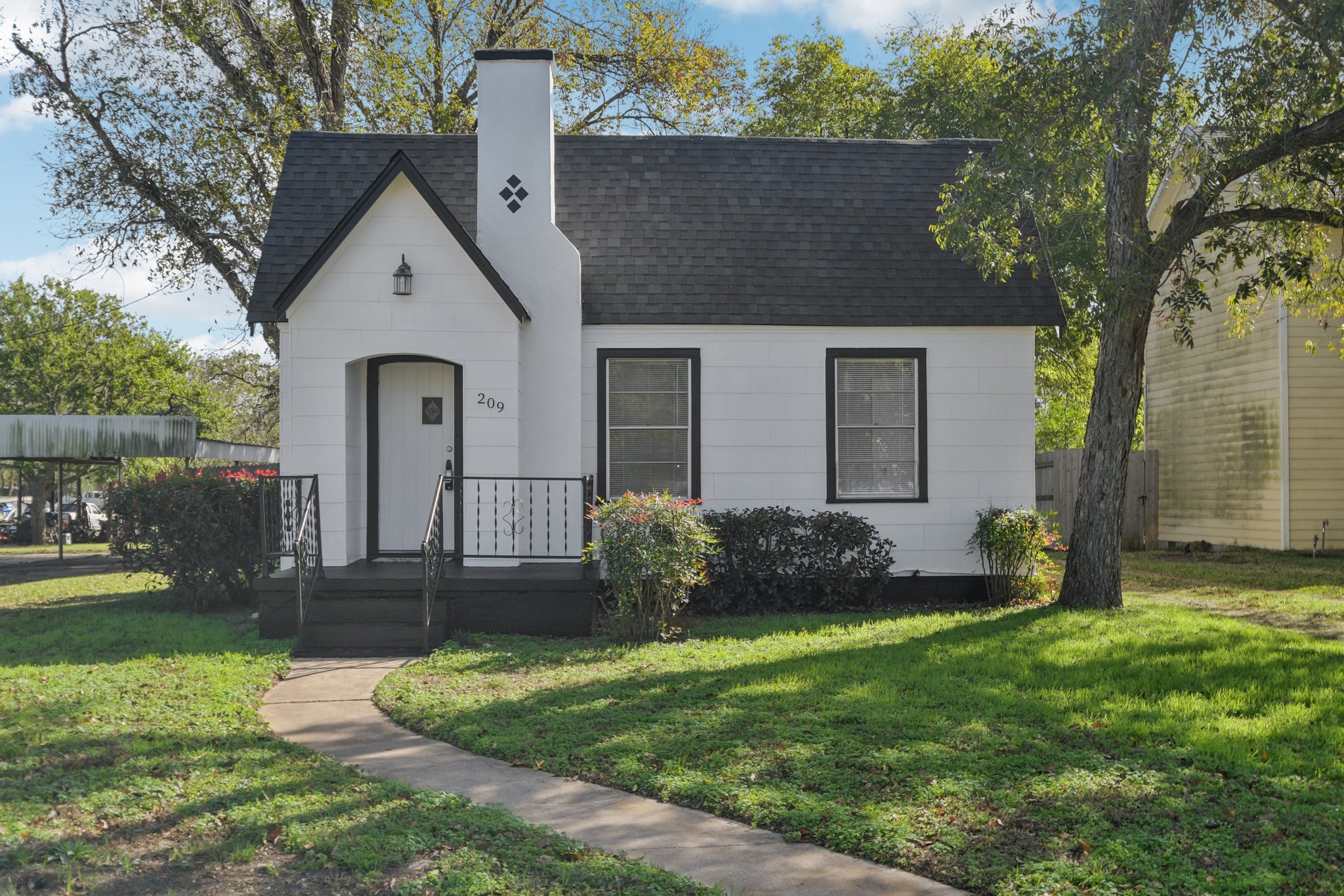 a front view of a house with a garden