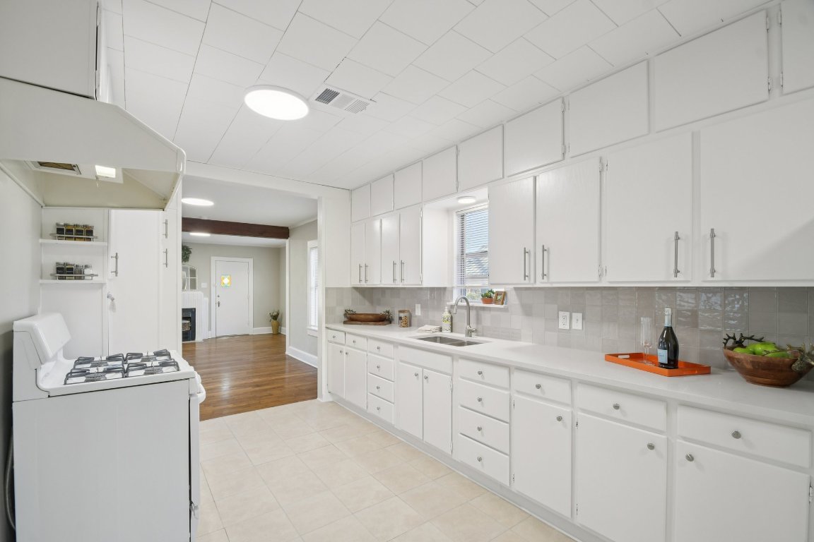 209 East 8th Street Elgin, TX 78621 - Photo 11 of 23 a kitchen with sink and cabinets
