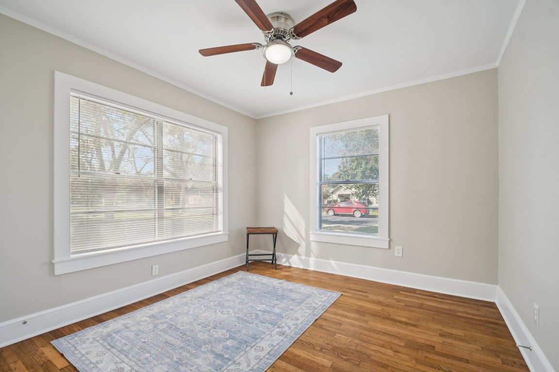 209 East 8th Street Elgin, TX 78621 - Photo 16 of 23 a view of an empty room with a window and wooden floor