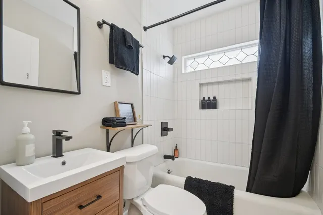 a bathroom with a sink a toilet and bathtub