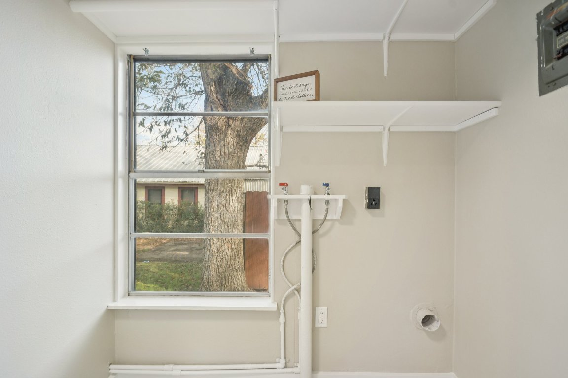 209 East 8th Street Elgin, TX 78621 - Photo 18 of 23 a bathroom with a window and a shower