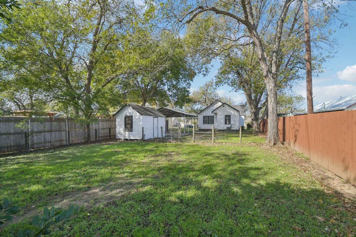 209 East 8th Street Elgin, TX 78621 - Photo 22 of 23 a house with green field in front of it