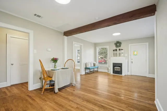a living room with furniture a fireplace and a table