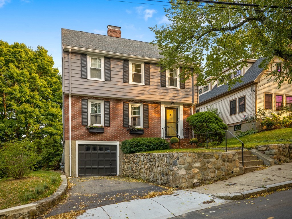 a front view of a house with garden