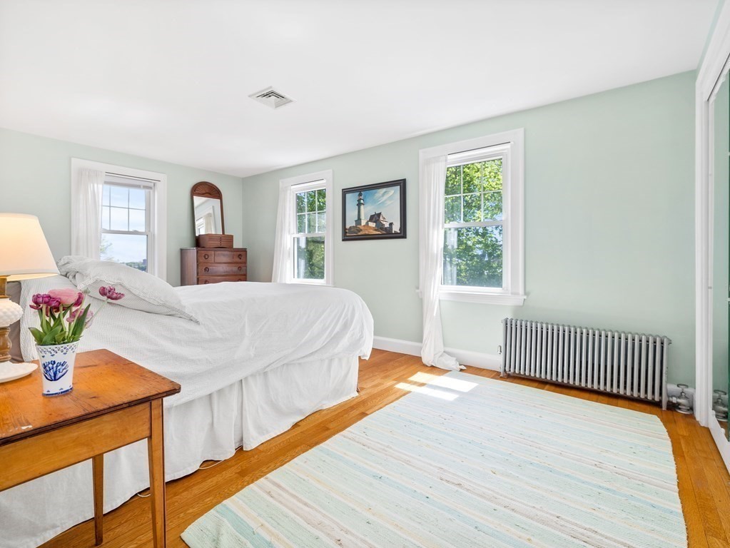 4 Malcolm Road Boston, MA 02130 - Photo 17 of 34 a bedroom with a bed and wooden floor