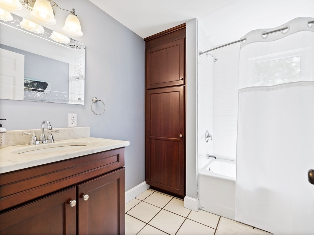 4 Malcolm Road Boston, MA 02130 - Photo 19 of 34 a bathroom with a sink a mirror and a shower