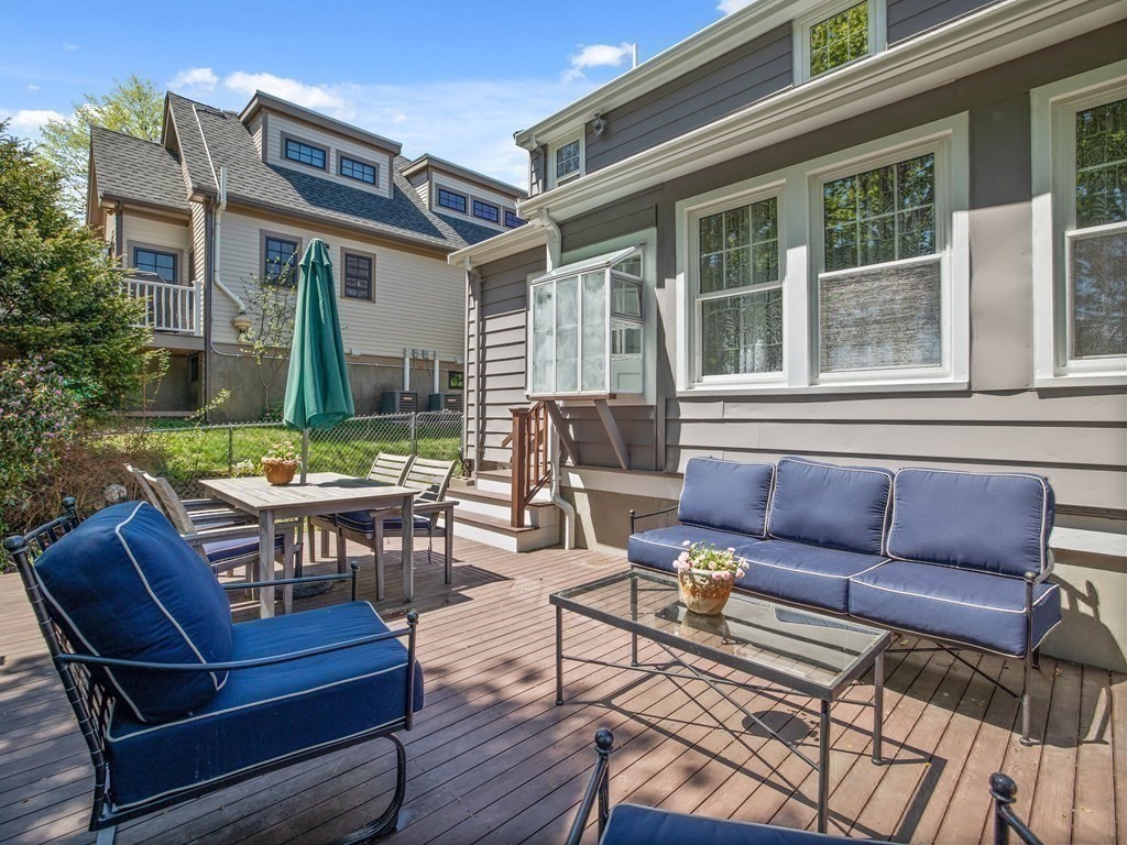 4 Malcolm Road Boston, MA 02130 - Photo 22 of 34 a view of a patio with couches chairs dining table and chairs