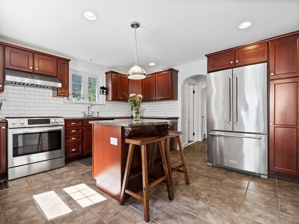 4 Malcolm Road Boston, MA 02130 - Photo 9 of 34 a kitchen with stainless steel appliances granite countertop a stove a refrigerator and a sink