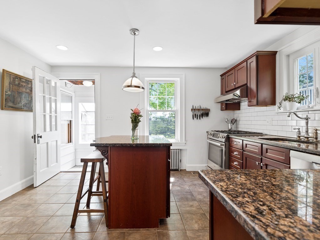 4 Malcolm Road Boston, MA 02130 - Photo 10 of 34 a kitchen with stainless steel appliances granite countertop a sink stove and refrigerator