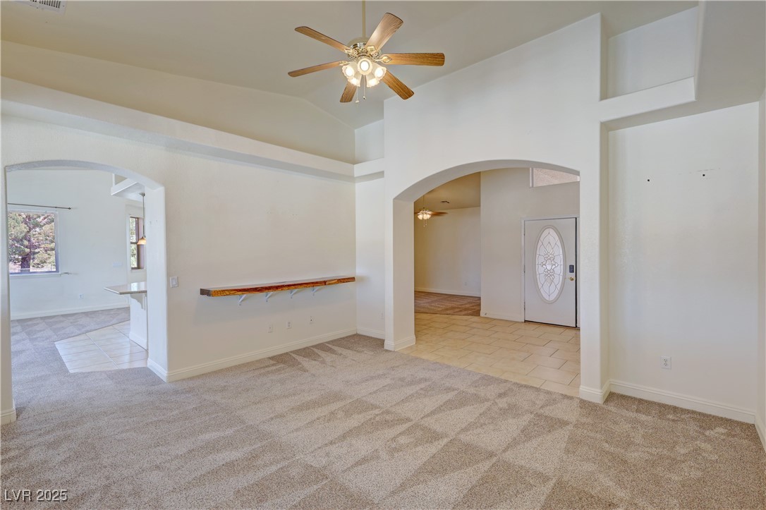 1771 Labrador Street Pahrump, NV 89048 - Photo 12 of 64 Unfurnished room with ceiling fan, carpet, arched walkways, and lofted ceiling