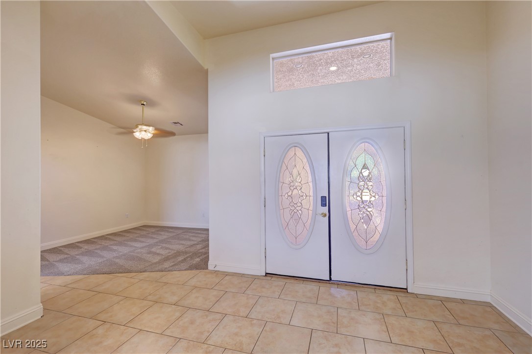 1771 Labrador Street Pahrump, NV 89048 - Photo 13 of 64 Foyer featuring high vaulted ceiling, a ceiling fan, light carpet, and light tile patterned floors