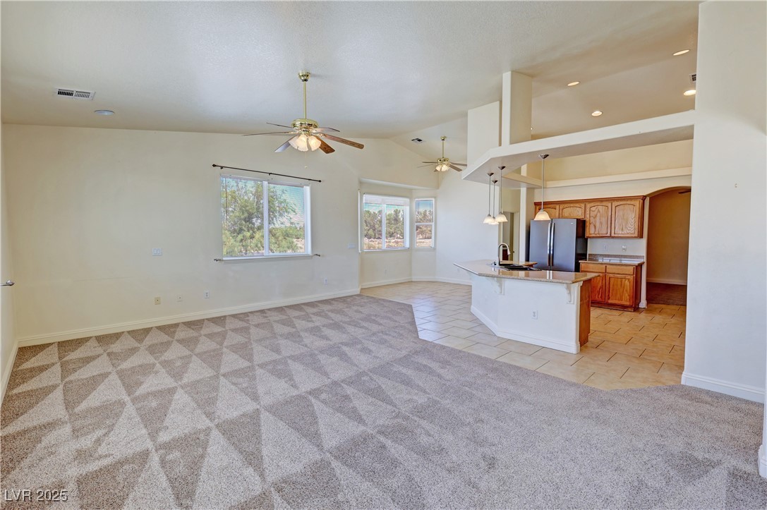 1771 Labrador Street Pahrump, NV 89048 - Photo 64 of 64 Kitchen with freestanding refrigerator, light carpet, open floor plan, light tile patterned flooring, and a ceiling fan