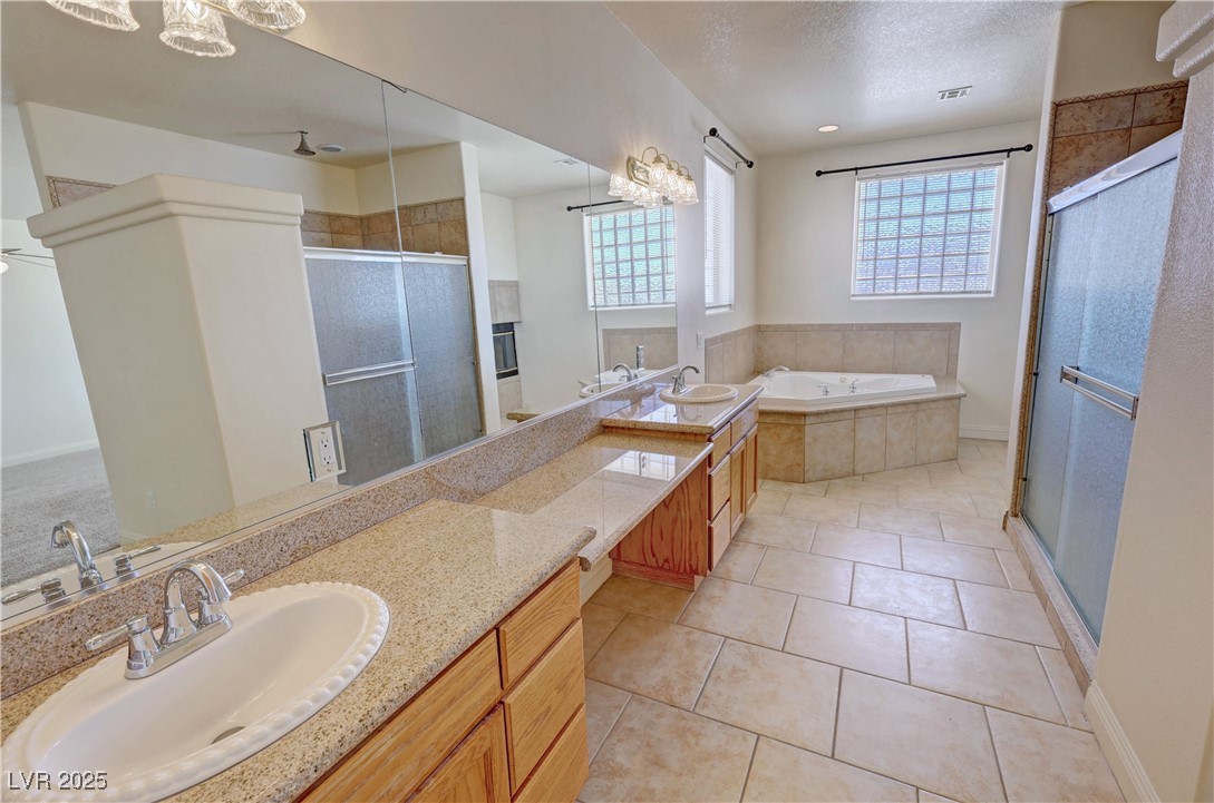 1771 Labrador Street Pahrump, NV 89048 - Photo 31 of 64 Full bathroom with a stall shower, vanity, a bath, and tile patterned flooring