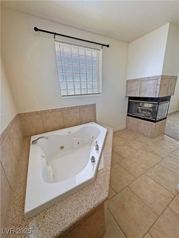 1771 Labrador Street Pahrump, NV 89048 - Photo 33 of 64 Bathroom with a tiled fireplace, a jetted tub, and a textured ceiling