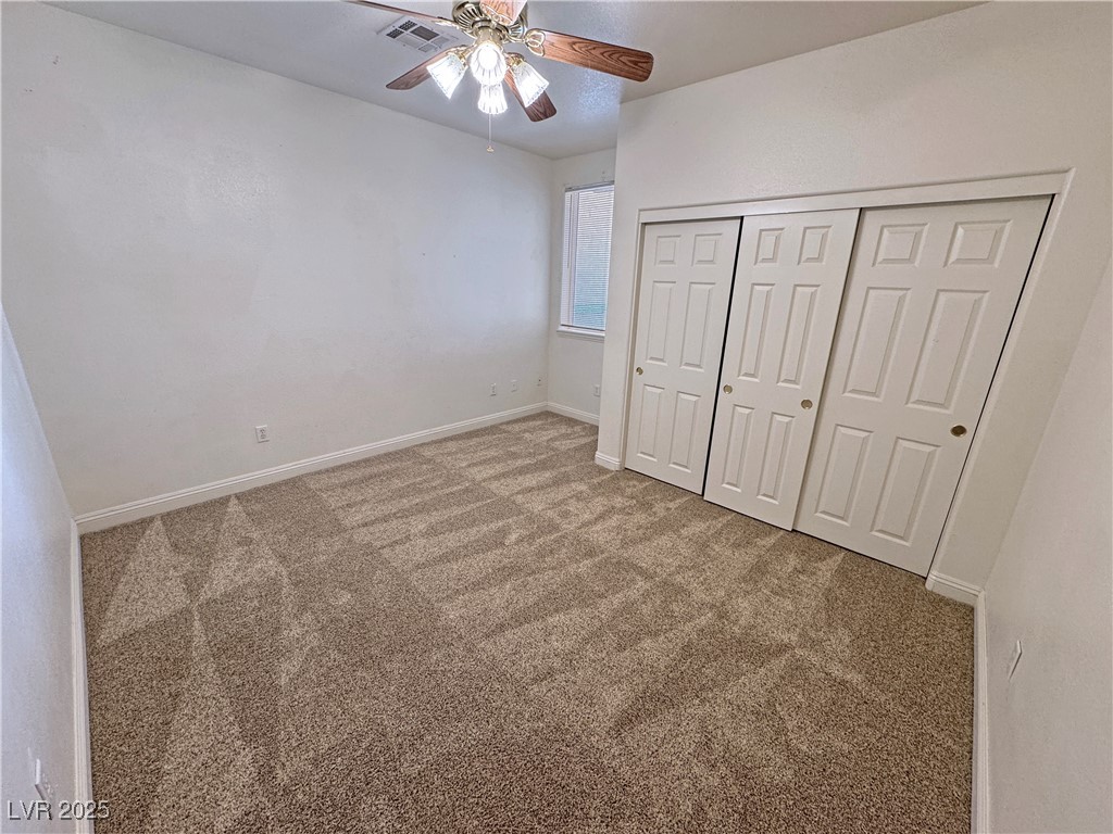 1771 Labrador Street Pahrump, NV 89048 - Photo 38 of 64 Unfurnished bedroom with carpet, a closet, and a ceiling fan