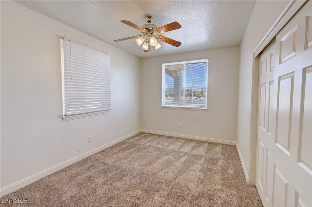 1771 Labrador Street Pahrump, NV 89048 - Photo 44 of 64 Unfurnished bedroom featuring light carpet, a closet, and ceiling fan