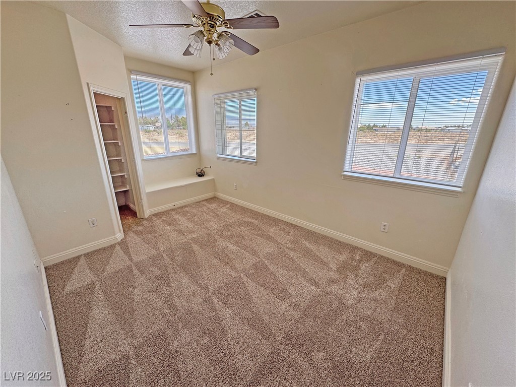 1771 Labrador Street Pahrump, NV 89048 - Photo 45 of 64 Empty room with ceiling fan and light carpet