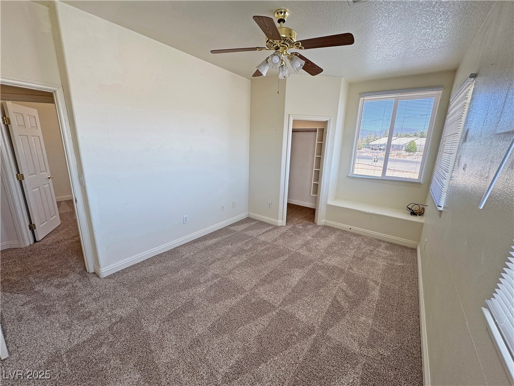 1771 Labrador Street Pahrump, NV 89048 - Photo 46 of 64 Unfurnished bedroom with carpet floors, a spacious closet, and a ceiling fan