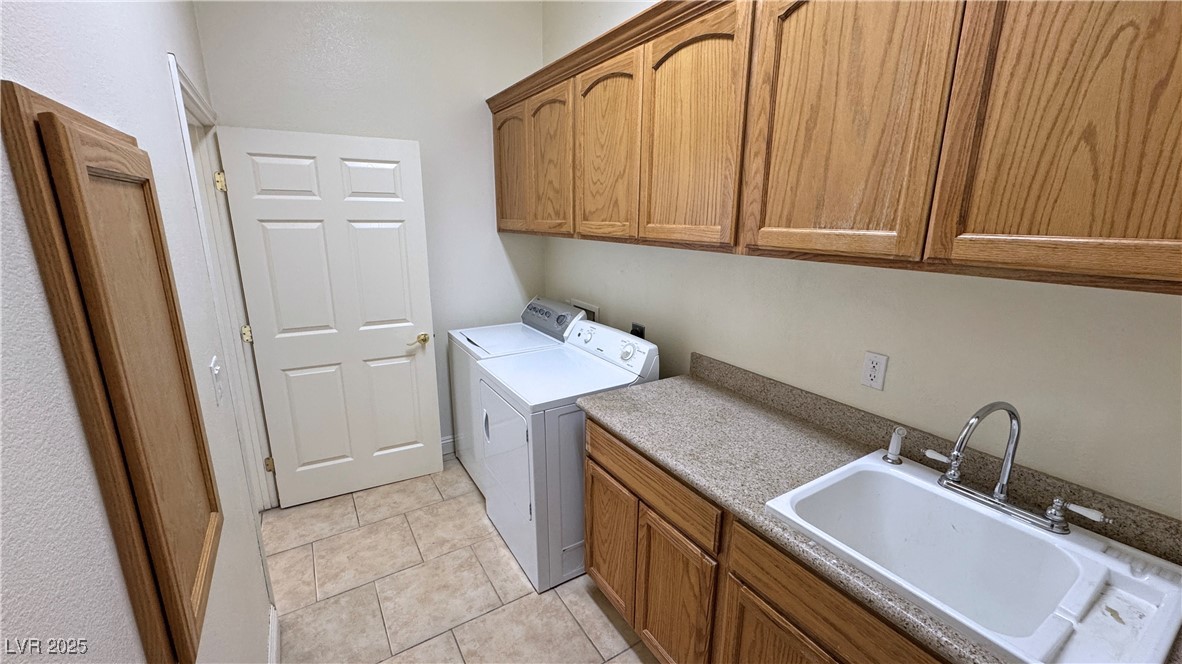1771 Labrador Street Pahrump, NV 89048 - Photo 47 of 64 Laundry area featuring cabinet space, washing machine and dryer, and light tile patterned flooring