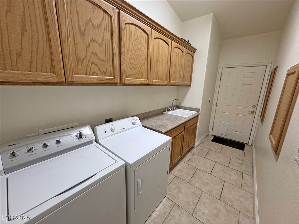 1771 Labrador Street Pahrump, NV 89048 - Photo 48 of 64 Laundry area with cabinet space, separate washer and dryer, and light tile patterned flooring