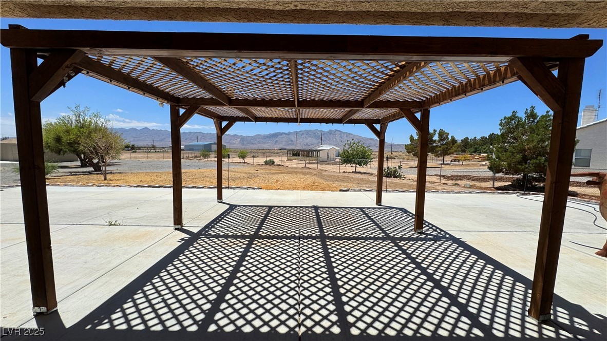 1771 Labrador Street Pahrump, NV 89048 - Photo 57 of 64 View of patio featuring a mountain view and a pergola