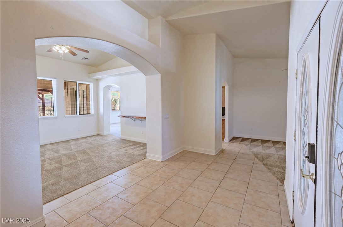 1771 Labrador Street Pahrump, NV 89048 - Photo 8 of 64 Foyer entrance featuring light carpet, ceiling fan, arched walkways, and light tile patterned floors