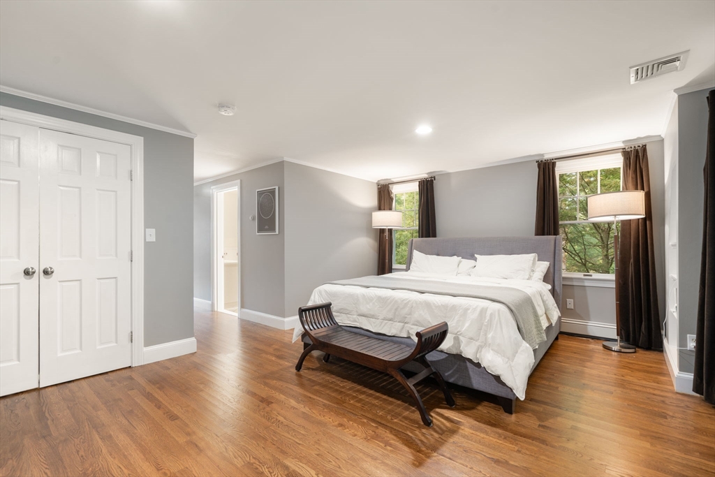 61 Silver Hill Road Weston, MA 02493 - Photo 17 of 39 a spacious bedroom with a bed and wooden floor
