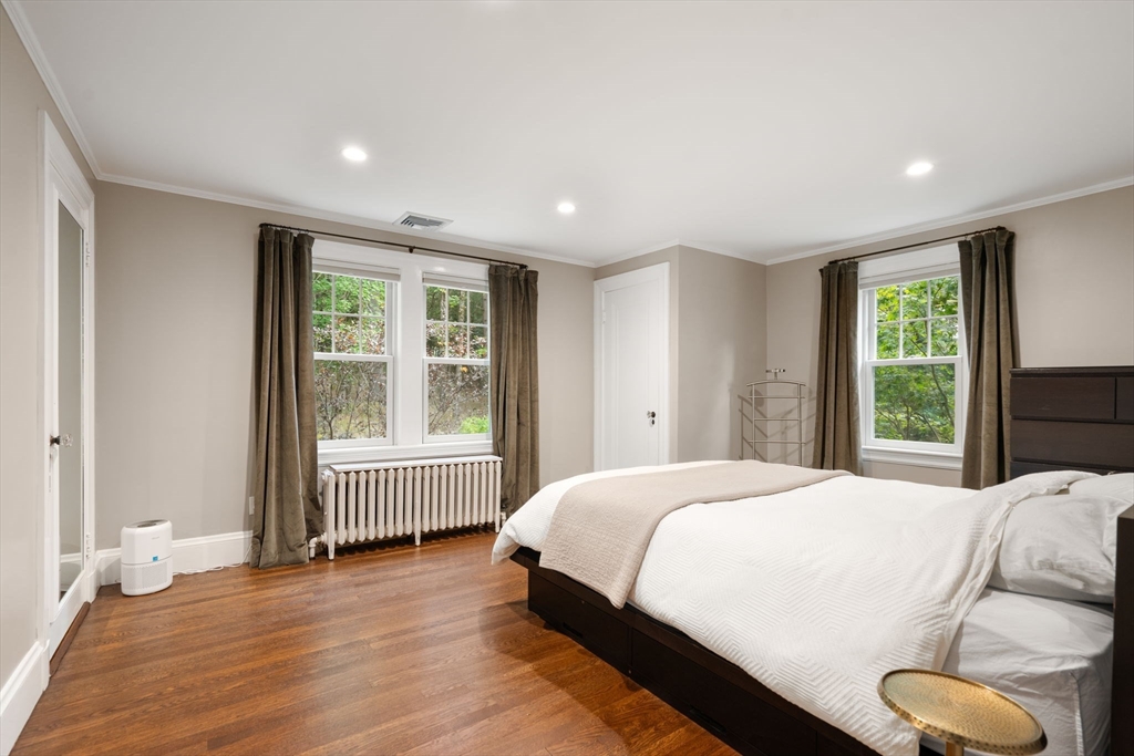 61 Silver Hill Road Weston, MA 02493 - Photo 20 of 39 a bedroom with a bed and wooden floor