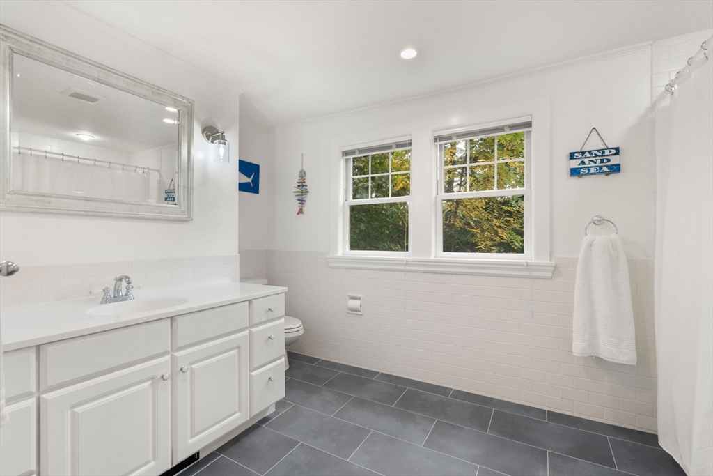 61 Silver Hill Road Weston, MA 02493 - Photo 21 of 39 a bathroom with a sink a toilet and a window